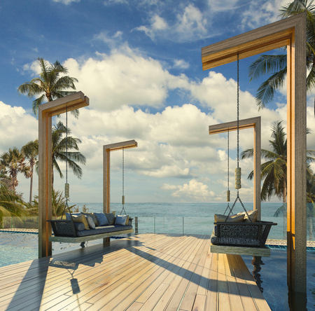Beautiful Swing sofa on the Swimming pool waters outdoor tropical beach coastline with blue ocean sea horizonの写真素材