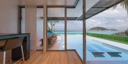 Beautiful view of Modern Sea House with  the sea, Lounge chairs on white floor deck at vacation home  - 3d renderの写真素材