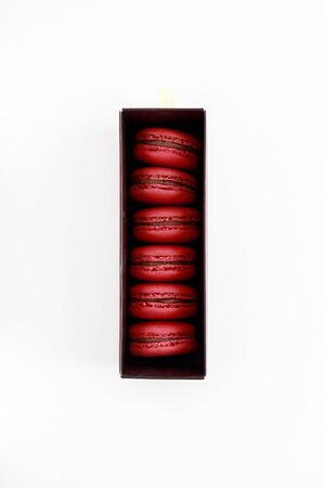Red macarons in the box isolate from white background. Macaron in the box for Valentine Day. Macaroon is French dessert use as a gift in celebration occasion such as wedding day or anniversary day.の写真素材