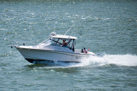 Boat quickly floats on the waves on a sunny dayの写真素材