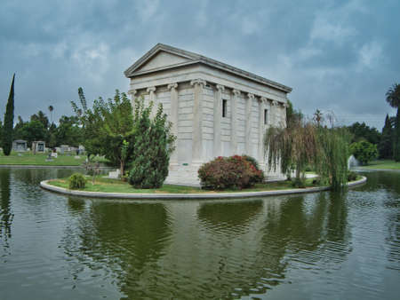Crypt surrounded by trees and a lakeの写真素材