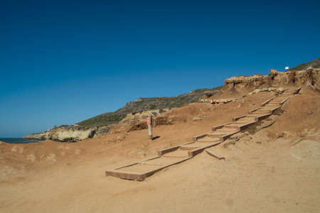 stone staircase on the sand next to the oceanの写真素材