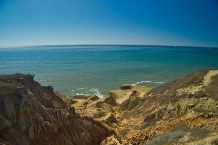steep mountain descent to the water near the oceanの写真素材