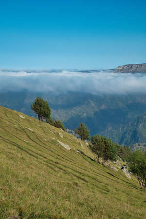 soaring clouds against the backdrop of the mountainの写真素材