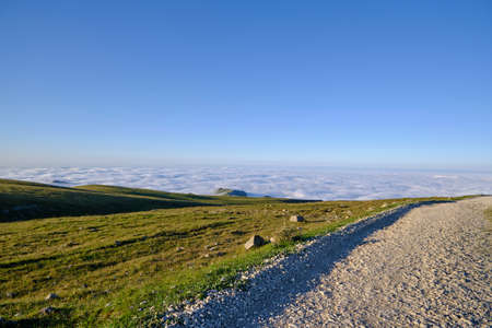 mountain road to the heaven blue sky and cloudsの写真素材