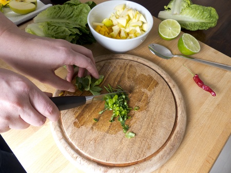 Chopped herbs on a wooden board 

の写真素材