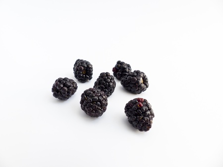 Cut as blackberries on white background の写真素材