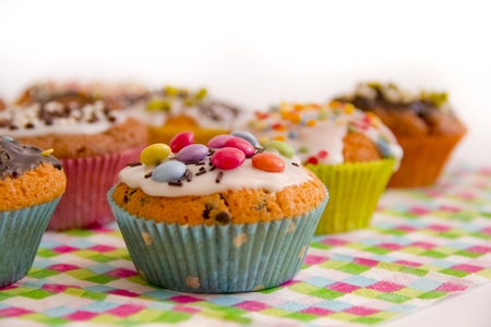 Many colorful muffins on colorful serving 