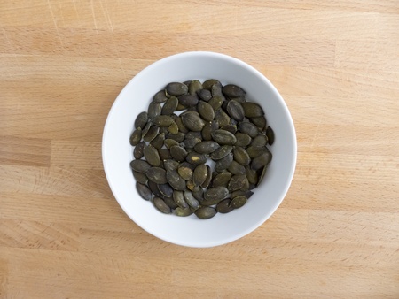 Pumpkin seeds on a wooden board

の写真素材