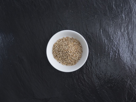 Sesame seeds in a bowl slate の写真素材
