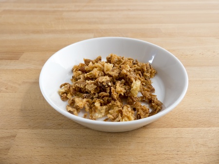 Roasted onions in a bowl on wood の写真素材