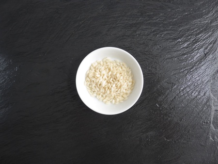 Risotto rice in a bowl slate の写真素材