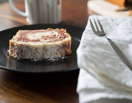 Marble cake with icing sugar on a plate の写真素材