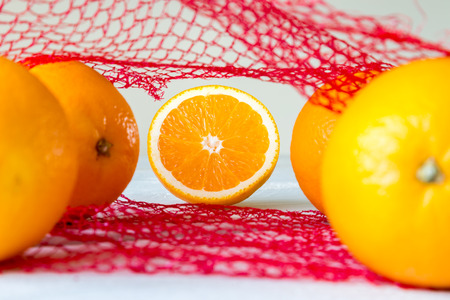 Oranges on a wooden table in the net bag