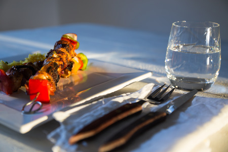 Curry chicken skewers with rice on white plateの写真素材