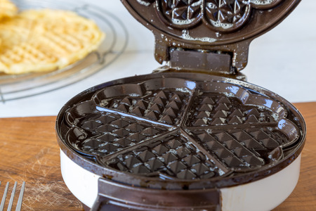 Homemade waffles are cooked in a waffle iron