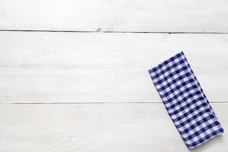 Blue kitchen towel on light wood の写真素材