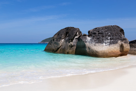 White sand beach and turquoise blue sea under a blue sky.の写真素材
