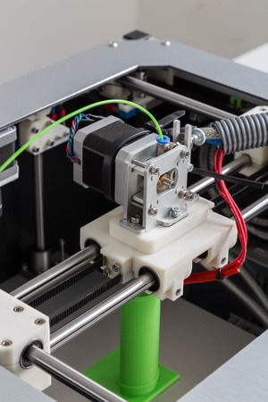 3d printer with bright green filament.の写真素材