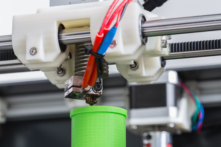 3d printer with bright green filament.の写真素材