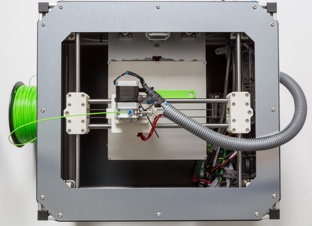 3d printer with light green filament.