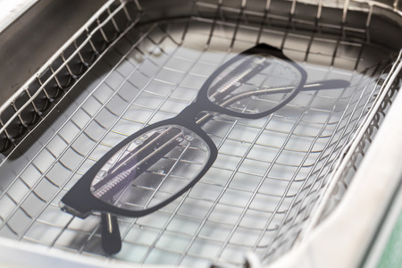 Professional cleaning glasses with an ultrasonic cleaner.