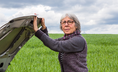 Car has breakdown Senior Woman hood opens.の写真素材