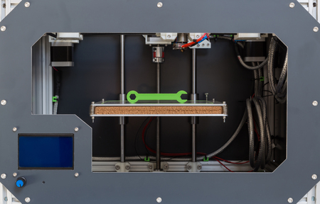 3d printer with bright green filament.