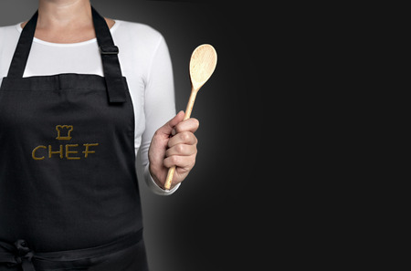empty template cook holding wooden spoon background concept.の写真素材