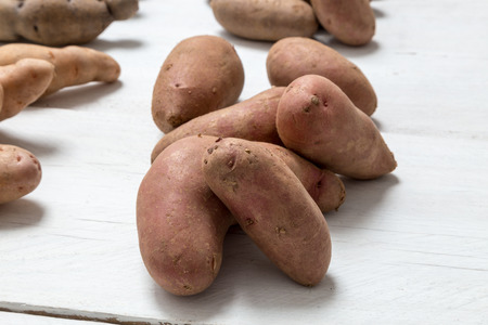 Potatoes on white wooden board Concept.の写真素材