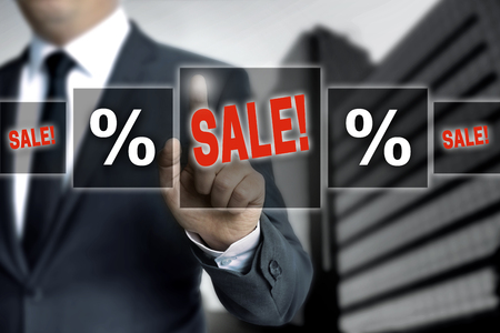 Sale touchscreen is operated by businessman.の写真素材