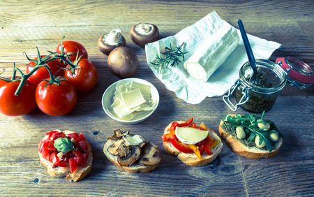 Bruschetta with beans and arugula, mushrooms, goat cheese.の写真素材