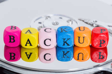 Backup letter cubes on hard disk concept.