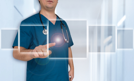 Doctor pointing at futuristic touchscreen template concept.の写真素材