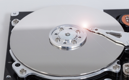 Open hard drive with magnetic disk and writing head.の写真素材