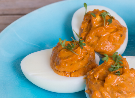 Stuffed eggs with cress on a plate.