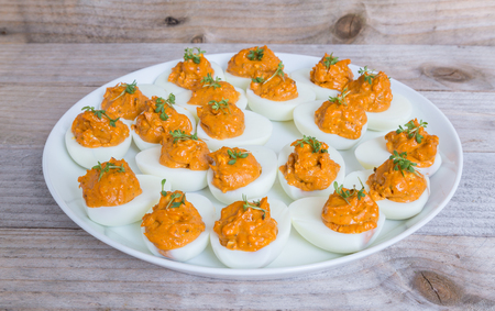 Stuffed eggs with cress on a plate.