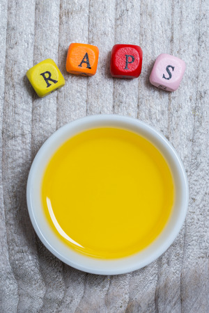 Raps (in german canola) with oil concept on gray wood.の写真素材