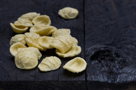 Orecchiette noodle on dark rustic wood.の写真素材