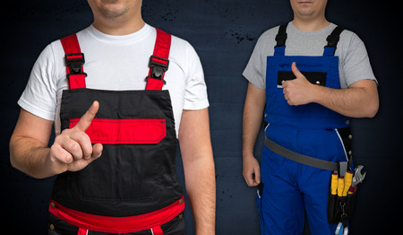 Craftsman points with finger and craftsman with thumbs up.の写真素材
