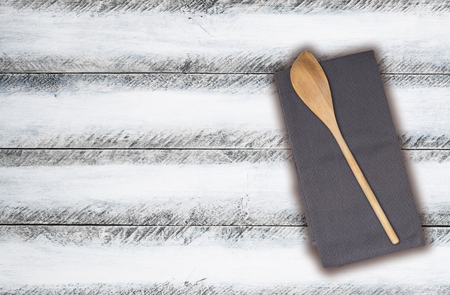 Wooden spoon and kitchen towel on white shabby chic.の写真素材