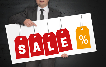 Sale labels poster is held by businessman.の写真素材