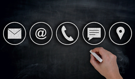 Contact options with chalk painted on blackboard.の写真素材