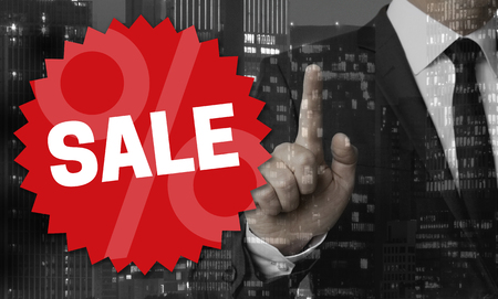 SALE concept is shown by businessman.の写真素材