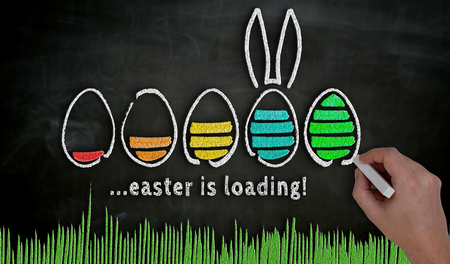 Easter concept painted by hand with chalk on blackboard.の写真素材