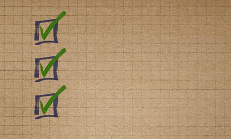 Checklist on checkered recycled paper writing pad conceptの写真素材