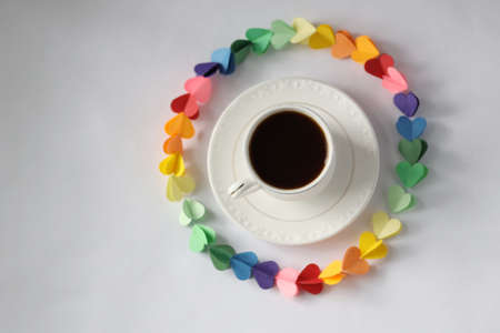 On a white background in the upper corner there is a decorative wreath made of multi-colored paper...