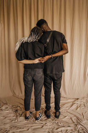 Black man and white woman holding hands together. Unity, familyの写真素材