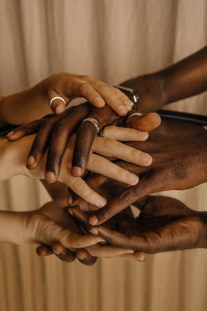 Multiracial hands of man and woman togetherの写真素材