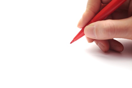 Female hand holding the red penの写真素材